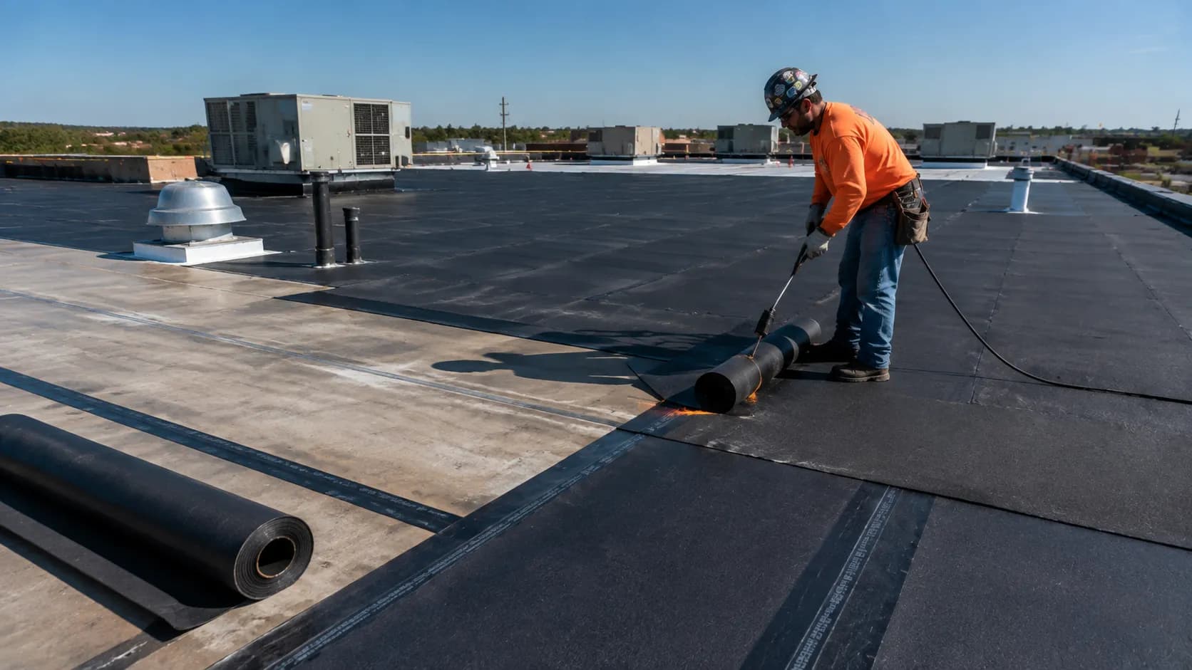 Modified bitumen roofing showing asphalt-based membrane layers